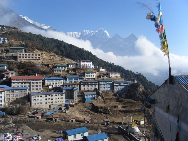 Village overlooking a mountain range with snow peaks.