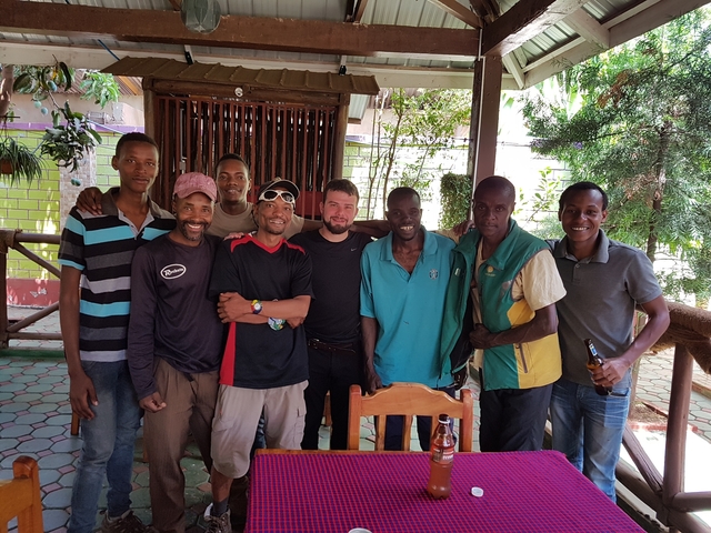 A group of people posing together outdoors.