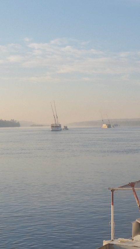 Sailboats on a calm river.