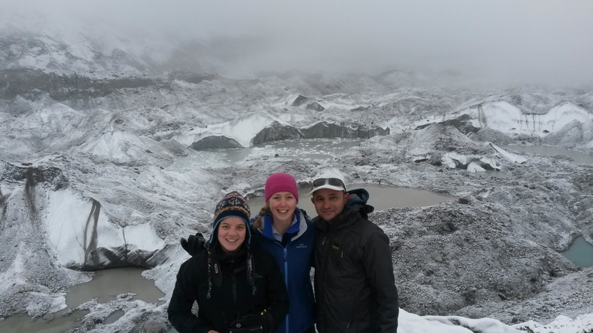 Group of people in a snowy mountainous landscape.