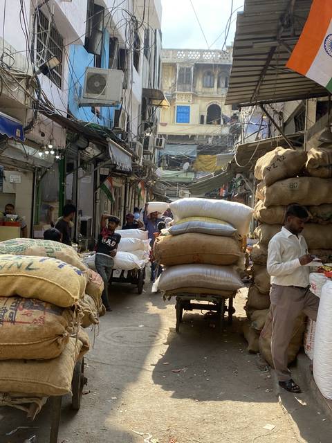 Busy street market with people and goods.
