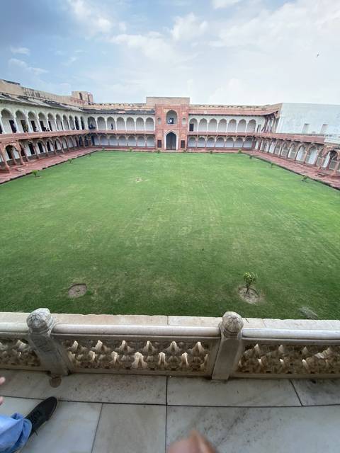 Extensive grass lawn in front of a fort.