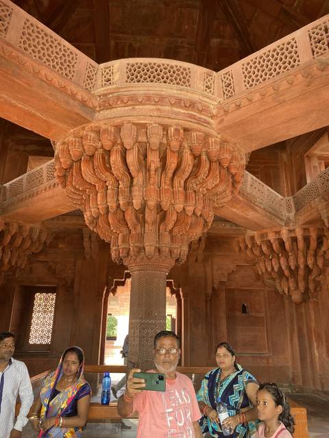 People gathering around a historical structure.