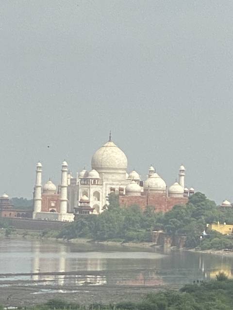 The Taj Mahal viewed from a distance across a body of water.