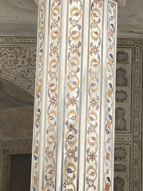 Intricate marble inlay work on a wall.