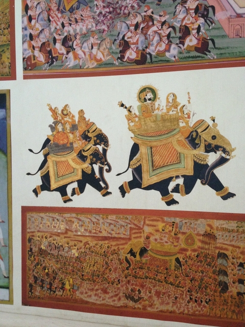 Traditional Indian art featuring elephants carrying a temple.