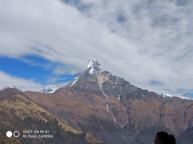 Snow-capped mountain peak under a clear sky.