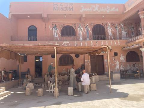 Upside-down image of people standing in an artistically designed room.
