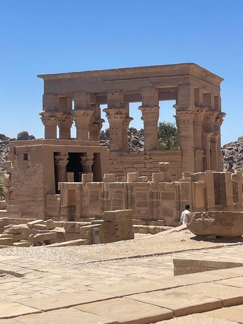 Ancient temple structure with columns in a desert setting.