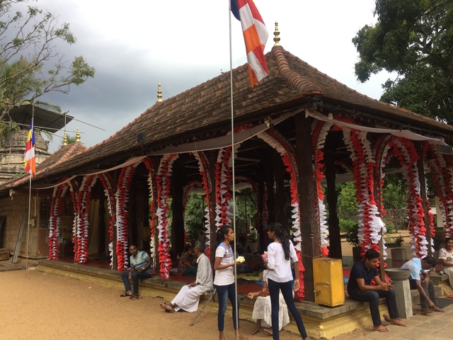 Decorated temple with visitors.
