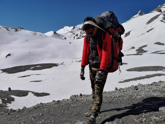 Person trekking in a snowy mountain region