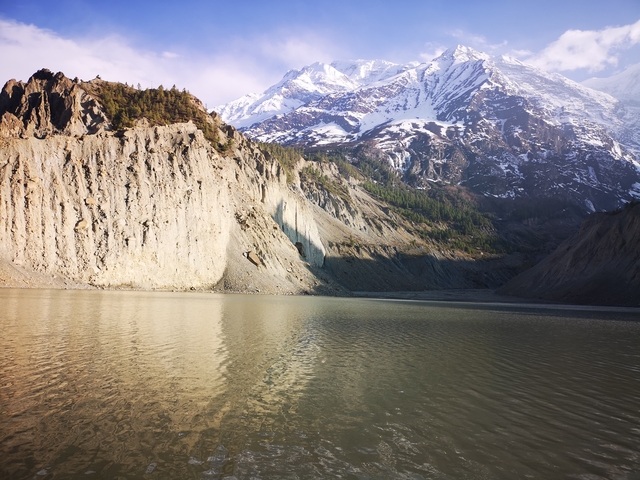 Reflective lake under snowy mountains