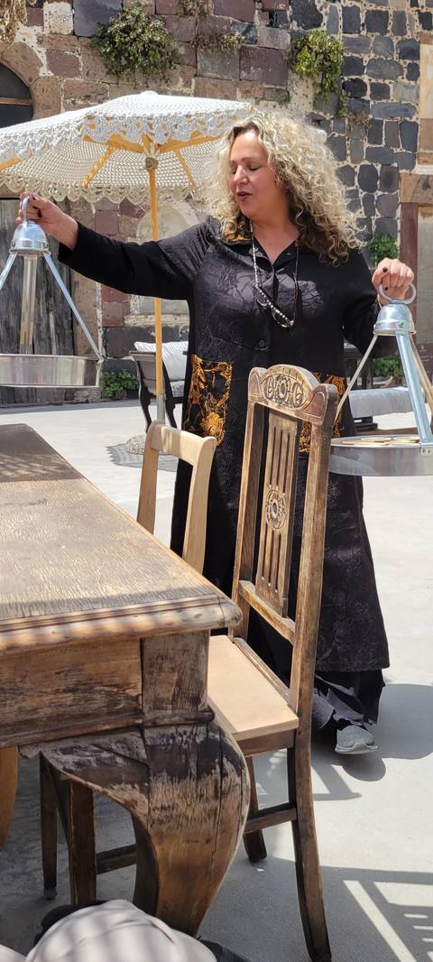 Woman standing with rustic decor.