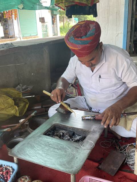 Artisan working with metal tools.