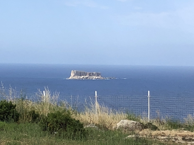 Small rocky island in the middle of the ocean.