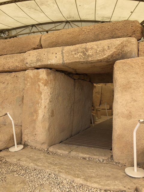 Ancient stone passageway with a rope guide.