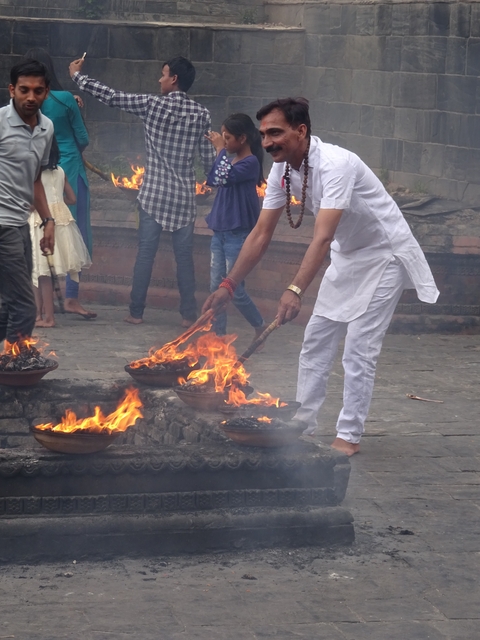 Person participating in a traditional fire ritual.