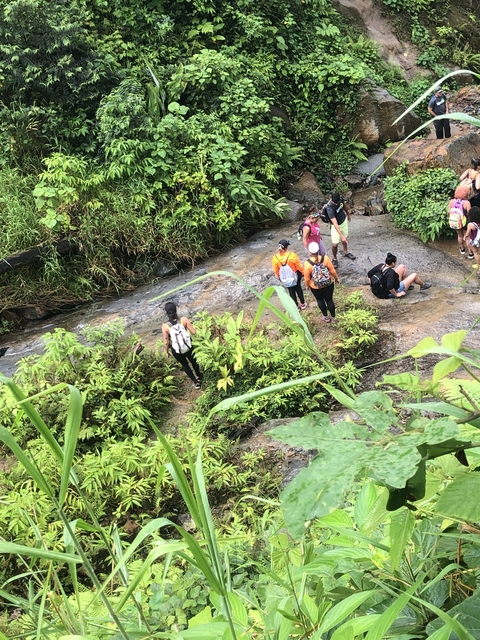 Group of people exploring a rocky area.