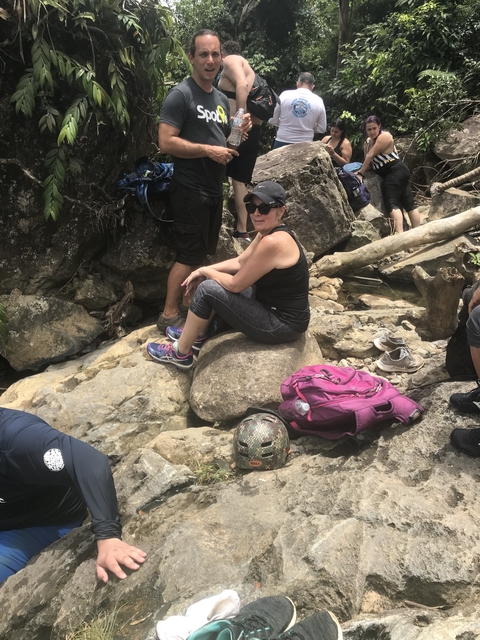 Woman sitting on rocks with a backpack.