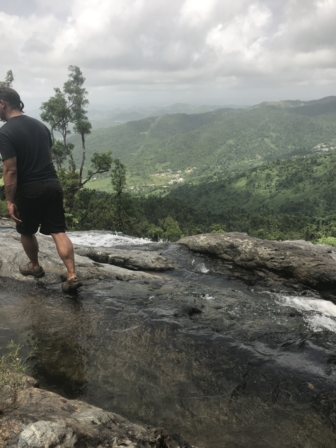 Person standing on a rocky river edge.