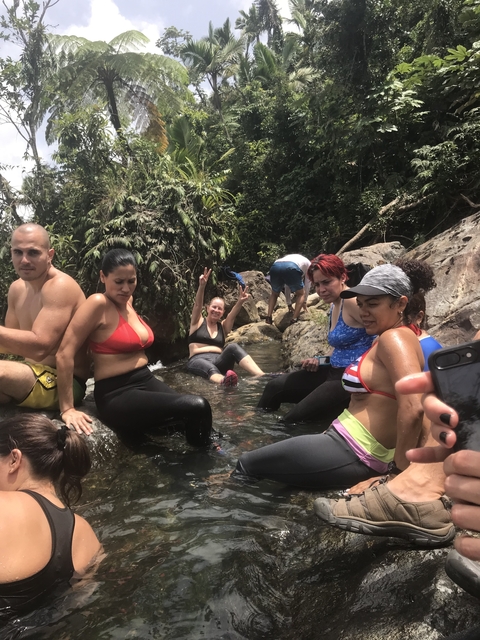 Group of people relaxing in a stream.