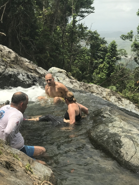 People enjoying a natural water feature.