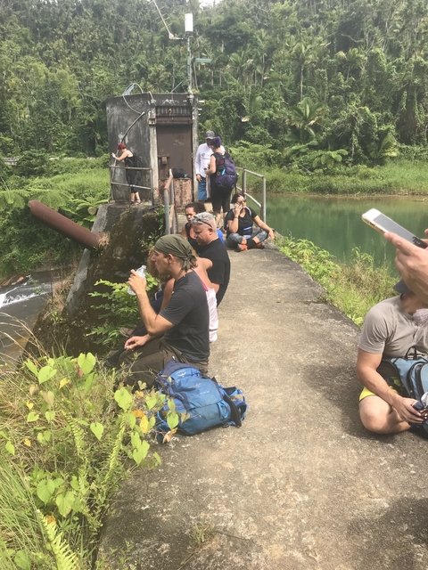 Group of people resting near a body of water.