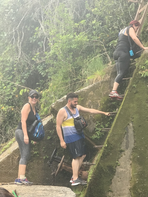 Group of people climbing a steep incline.