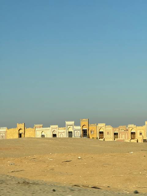 Desert fort structures against a blue sky.