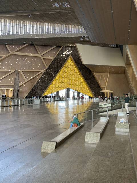 Large modern hall with a unique pyramid design inside a building.