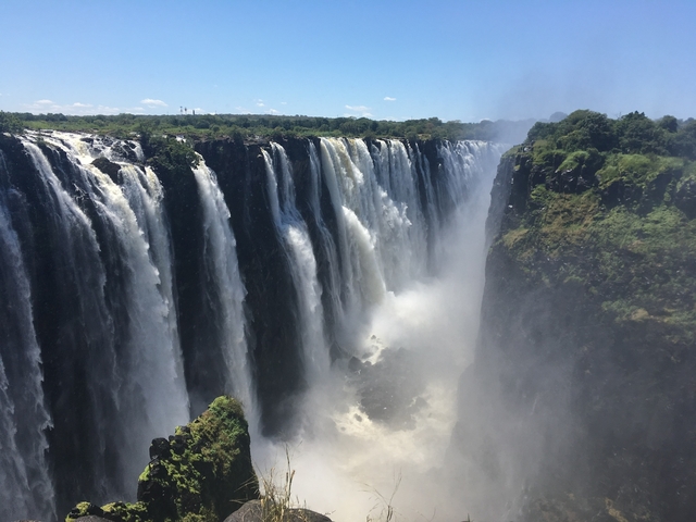 The powerful Victoria Falls cascading into a misty gorge.