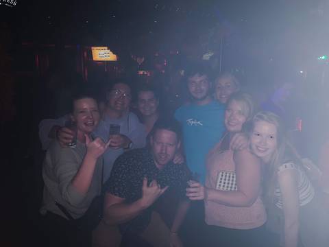 Group of people in a dimly lit bar.