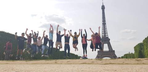 Group jumping in front of the Eiffel Tower.