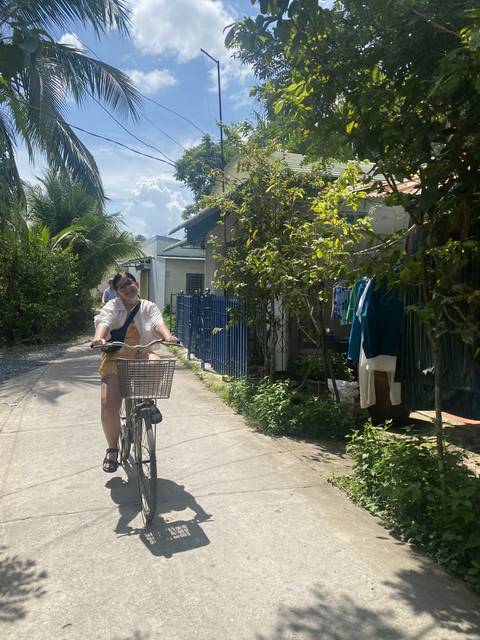 Person riding a bicycle along a rural path.