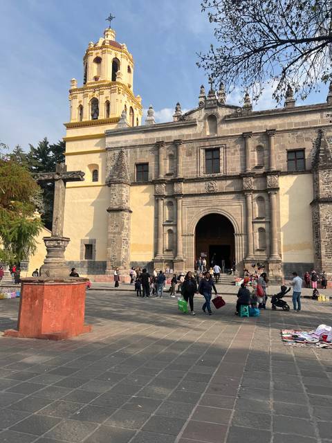 Historic cathedral with people in front.