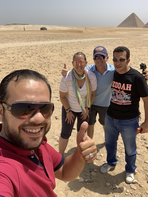 Group posing in a desert landscape.