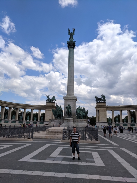 Large monument with statues and column.