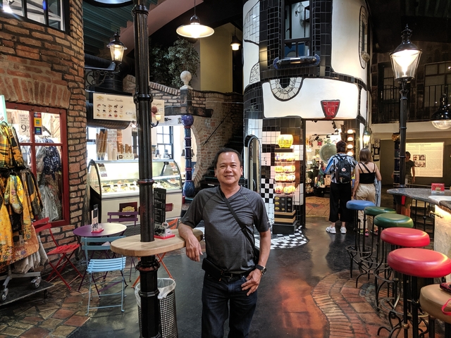 Man inside a colorful cafe with artistic decor.