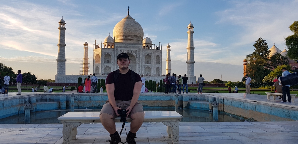 Tourist seated with the Taj Mahal in the background.