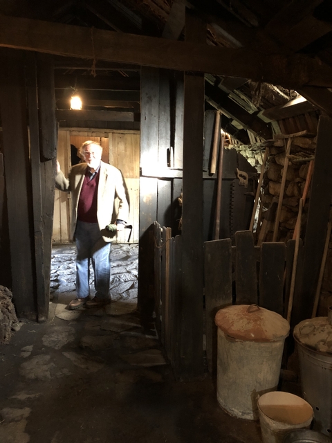 Man posing inside a dimly lit historical structure