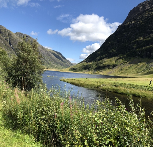 Scenic view of a river cutting through a green valley.