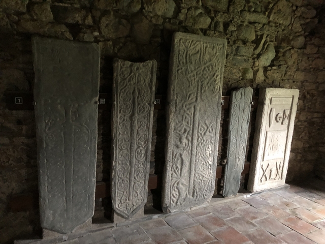 Row of ancient stone slabs with intricate patterns