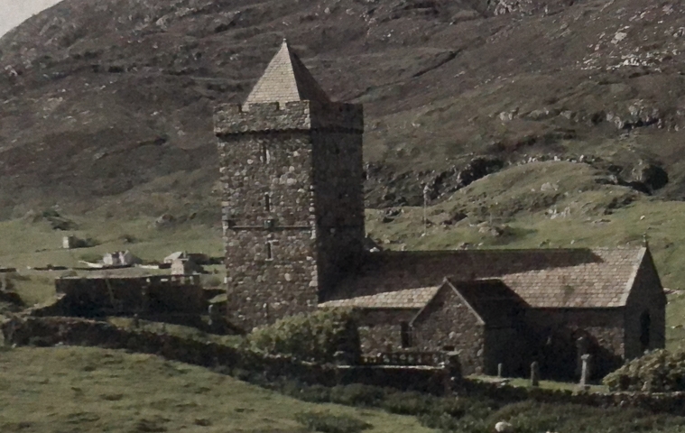 Stone church tower in a rural hilly landscape