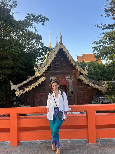 Person standing in front of a decorated temple.