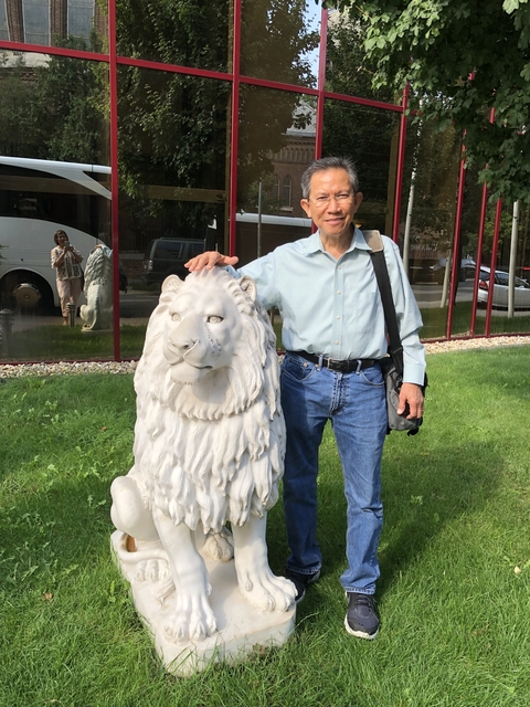 Person touching a lion sculpture