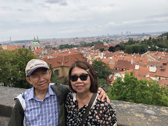 Couple posing above city with panoramic view