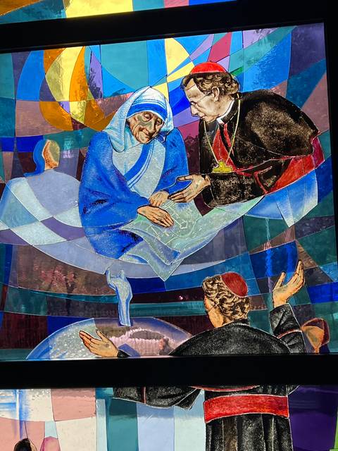 Colorful stained glass depicting figures.