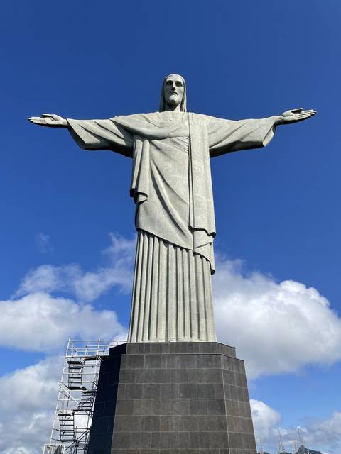 Christ the Redeemer statue against a blue sky.