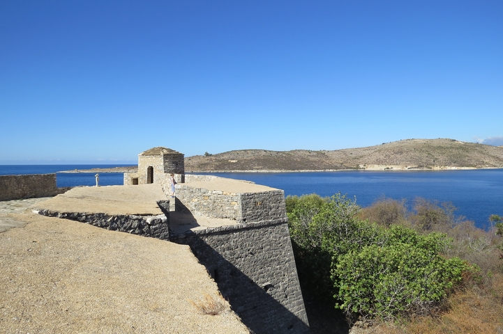 Stone wall and blue sea with clear skies.