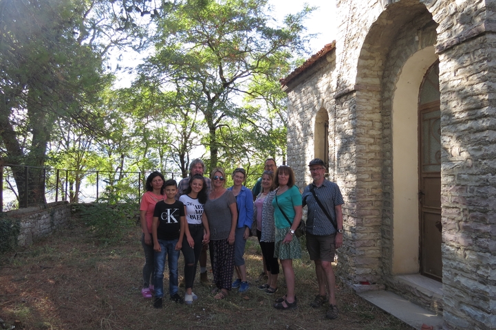 Group photo in front of a stone building.